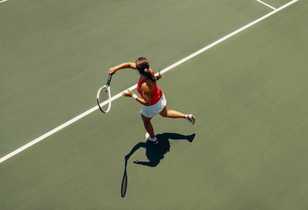 aerial view of female tennis player executing a forehand on court
